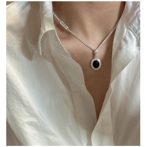 Detail of S925 silver necklace featuring black onyx pendant with vintage textures