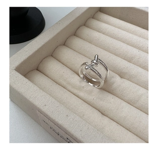 Macro detail of S925 sterling silver knot ring with Korea engraving on jewelry tray