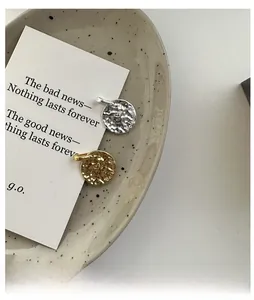 Detail of S925 silver pendant with hammer texture and Beginning engraved lettering