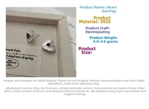 Macro detail of S925 sterling silver heart earrings with black texture and metal frame