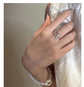 Detail of silver S925 sterling silver cross knot ring and chunky link bracelet for women