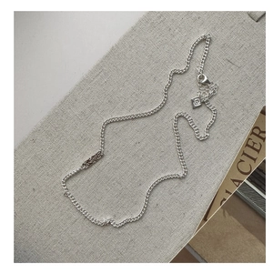 Detail of S925 silver necklace featuring flat link chain and embossed rectangle charm