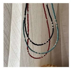 Detail view of s925 silver beaded necklaces with agate and turquoise stones in three colors