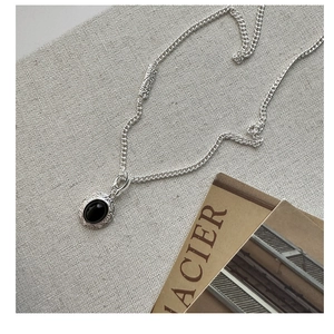Detail of S925 silver necklace featuring black onyx pendant with vintage textures