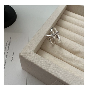Detailed view of S925 sterling silver knotted ring with Korea engraving on a velvet tray