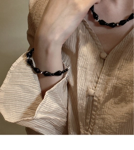 Detailed shot of s925 silver beaded necklace and bracelet with black agate teardrops