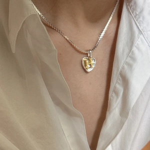 S925 silver heart necklace with gold H letter pendant on model wearing white shirt