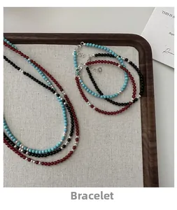 Detail of s925 silver beaded bracelets with turquoise and agate stones on a wooden tray