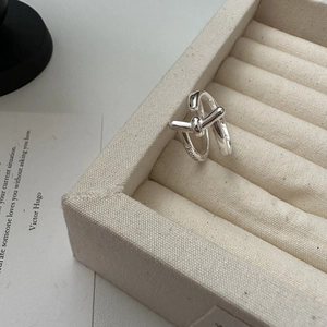 Minimalist S925 sterling silver knot ring with Korea engraving on beige velvet stand