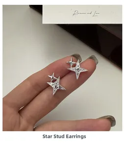Macro shot of silver awn star earrings featuring hammer texture and polished finish