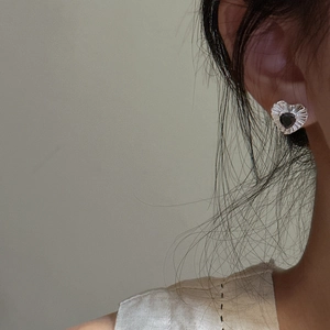 S925 sterling silver heart studs with black zircon stone worn by a model
