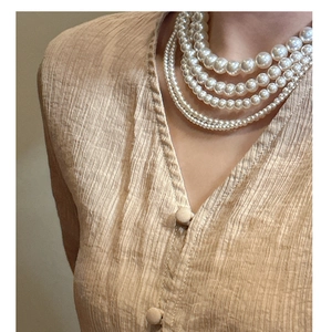 Gros plan d'un collier de perles multicouche en argent sterling S925 brillant sur un modèle