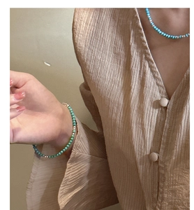 Detail of s925 silver beaded bracelet and necklace set with turquoise agate stones