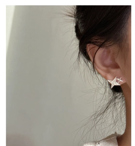 On-ear view of S925 silver star stud earrings featuring sparkling zircon stone details