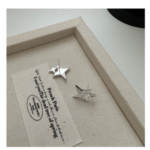 Macro detail of S925 sterling silver double star stud earrings with hallmark stamp