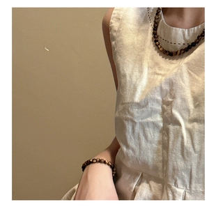 Detail of S925 silver tiger eye stone necklace and matching bracelet set with natural beads