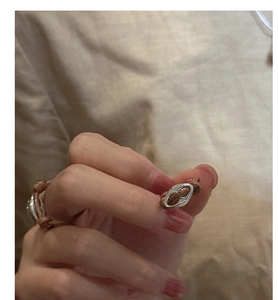 Detail of handcrafted brown woven rope ring featuring silver oval pig nose hardware