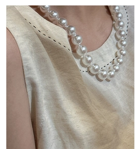 Close-up of elegant S925 sterling silver necklace featuring large round white pearls