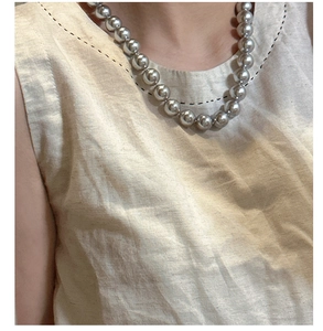 Close-up of minimalist S925 sterling silver ball chain necklace on a model's neck