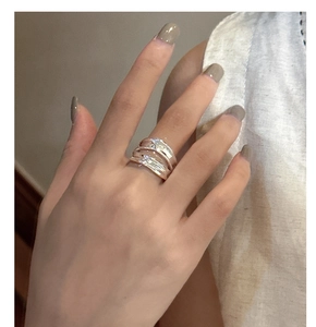 Detail view of a double-layered irregular silver ring with high-polish wavy surface