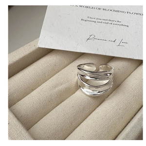 Macro detail of the triple-layered wave ring with polished silver finish and open band