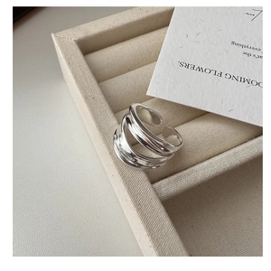 Detailed macro shot of a double-layered polished silver ring on a velvet jewelry case