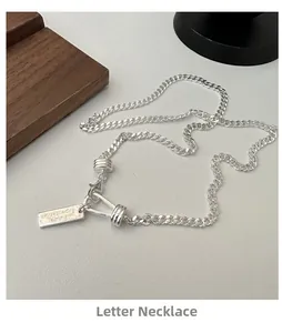 Detail of S925 sterling silver flat Cuban chain necklace with engraved rectangular tag