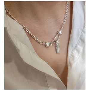 Close-up of S925 sterling silver chain necklace with Expectation Future engraved tag