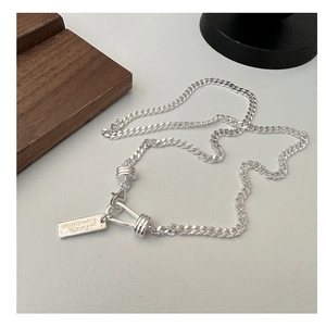 Macro detail of S925 sterling silver chain with Future Expectation engraved tag