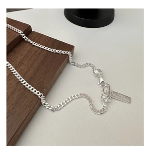 Detail of silver S925 necklace with rectangular tag engraved with Future Expectation text