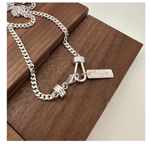 Detail of silver S925 curb chain necklace with Future Expectation engraved pendant