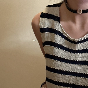 Chic striped knit tank top with cream and navy horizontal bands and round neckline