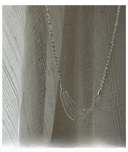 Macro shot of silver S925 layered tassel necklace showing sparkling chain details
