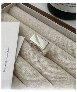Macro shot of polished S925 sterling silver square signet ring in a jewelry box