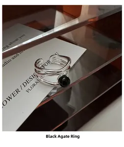 Detail of s925 silver multi-layer open ring featuring a polished black agate sphere