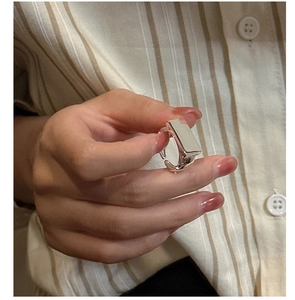 Macro shot of a minimalist square S925 sterling silver ring featuring a smooth polished surface
