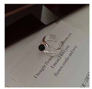 Detail view of S925 sterling silver triple-layer ring featuring a polished black onyx bead