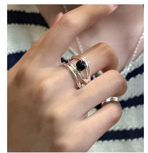 Close-up of S925 silver multi-strand ring with black onyx bead on model's finger