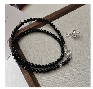 Detail of s925 silver mushroom pendant on double-layer black agate beaded chain necklace