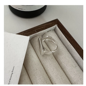 Close-up of geometric square bar silver ring inside a wooden velvet jewelry box