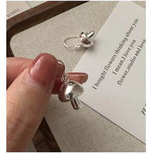 Detail view of S925 sterling silver mushroom earrings with shimmering crystal accents
