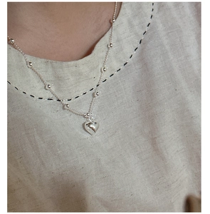 Detailed view of s925 silver heart pendant necklace with delicate beaded chain design