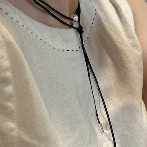 Minimalist S925 silver beaded long cord necklace featuring black rope with metal accents