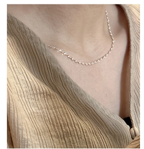 Detailed view of shimmering S925 sterling silver twisted rope chain necklace on model