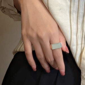 Minimalist S925 sterling silver square ring with a light green stone on model's hand