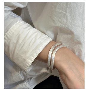 Detailed close-up of S925 sterling silver bracelets with fine vertical striped texture