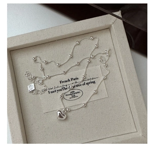 Detail of s925 silver heart pendant necklace with round beads and lobster clasp