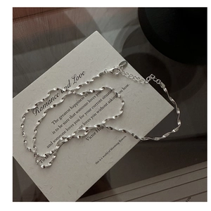 Close-up of S925 sterling silver water wave chain with lobster clasp and extension