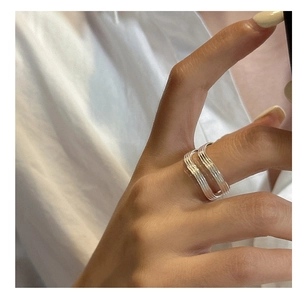 Detailed close-up of S925 sterling silver multilayer wavy band ring on hand
