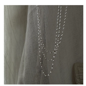 Detail of shimmering S925 sterling silver water wave chain with spiral texture